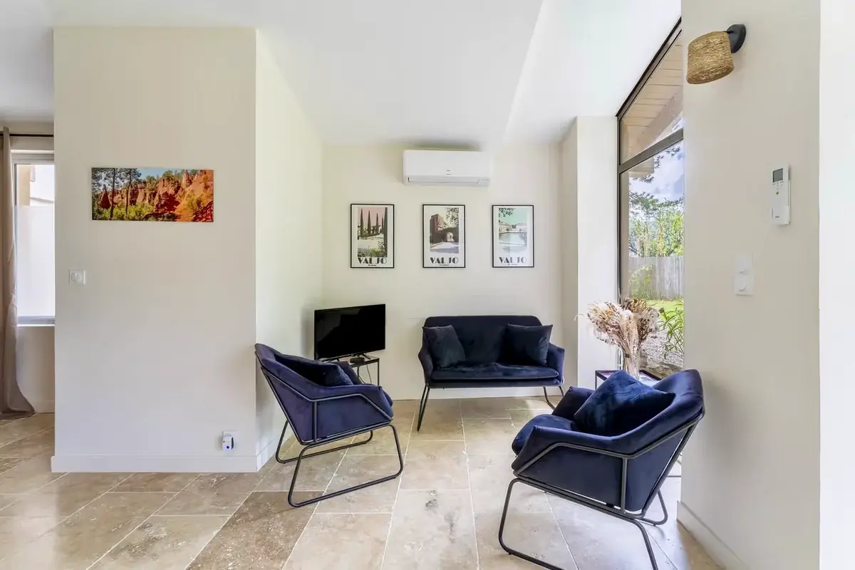 Sitting area with armchairs and television