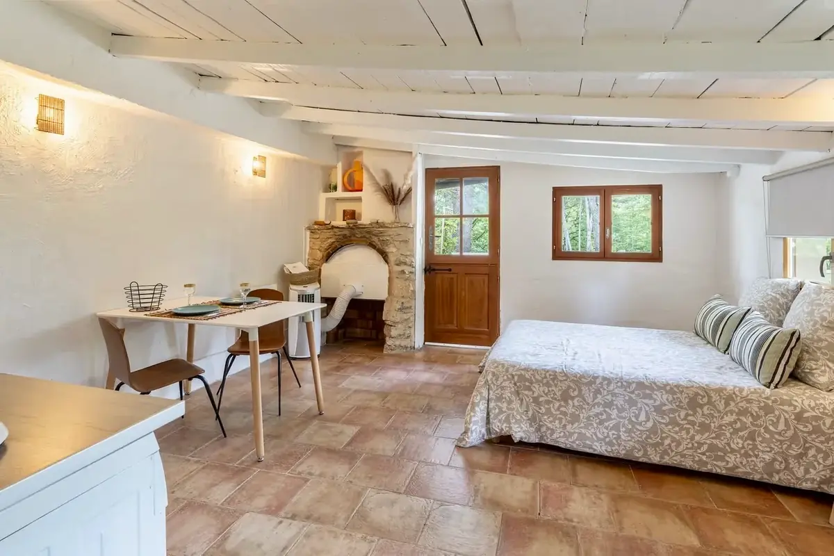 Living space of the studio: bed and dining area